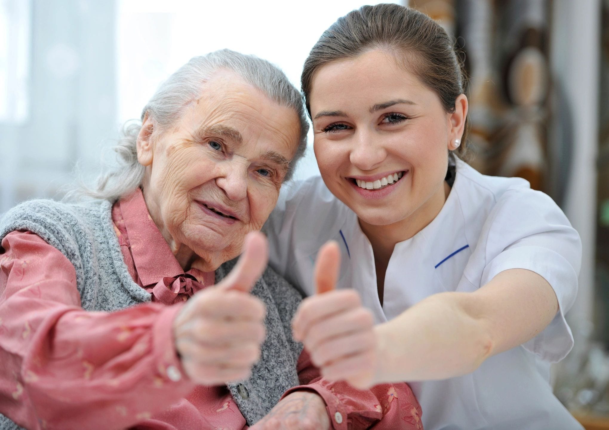 old woman and young woman thumbs up